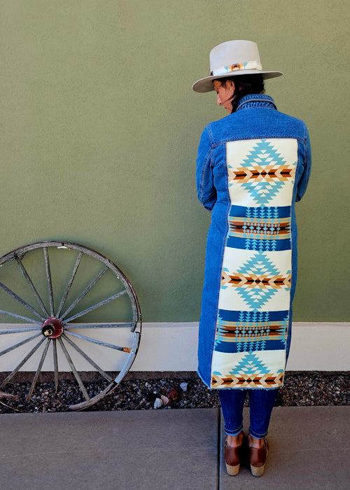 Back view of the Rancho Arroyo Aqua denim duster with a long turquoise and cream geometric wool panel.