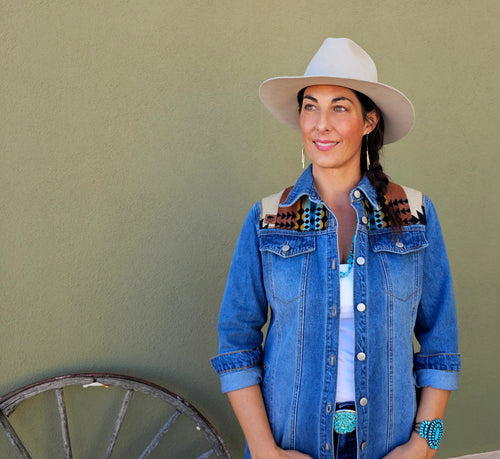 Front view of a woman wearing the Rancho Arroyo Black denim duster with patterned wool shoulder panels.
