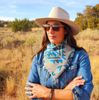 Front view of a woman wearing the Turquoise/Tan Aztec cowl over a denim jacket with her arms crossed.