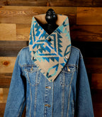 Turquoise/Tan Aztec cowl on a mannequin, showing its blue and tan geometric pattern over a denim jacket.