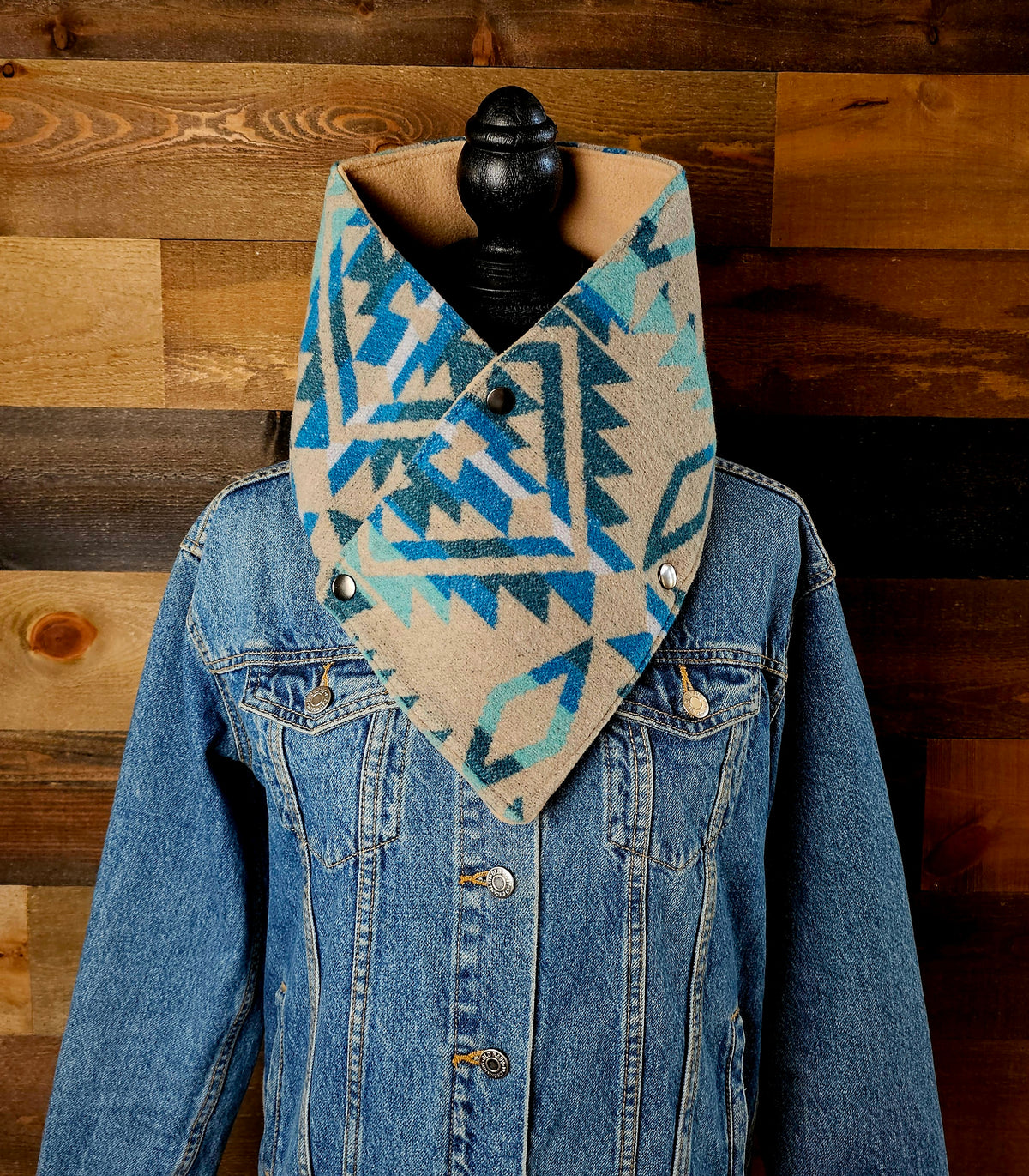 Turquoise/Tan Aztec cowl on a mannequin, showing its blue and tan geometric pattern over a denim jacket.