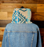 Back view of the Turquoise/Tan Aztec cowl above a denim jacket collar on a mannequin.