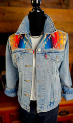 Front of the Pilot Rock denim jacket on a mannequin, with colorful geometric wool yokes and rolled sleeves.