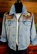 Front of the Land of the Buffalo denim jacket on a mannequin, with buffalo-patterned wool yokes and rolled cuffs.