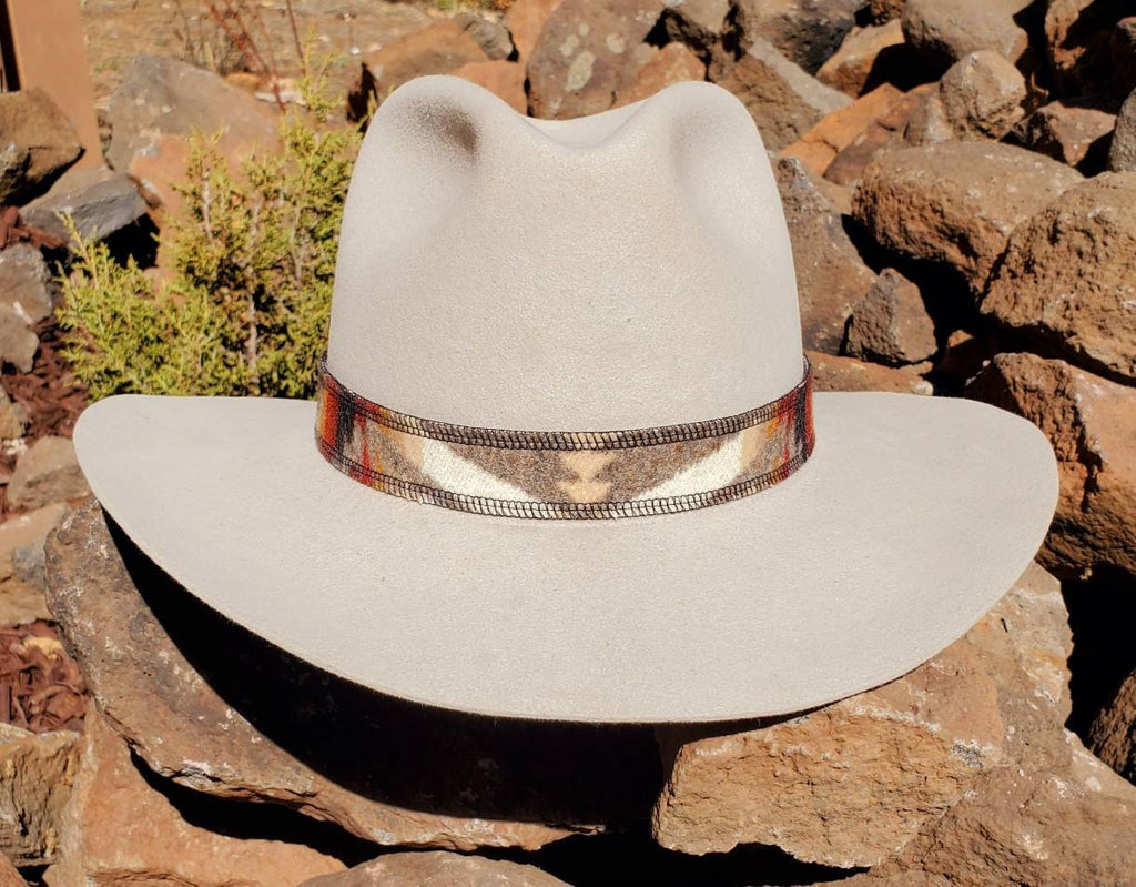 Front view of a light felt hat with the brown and cream geometric Pacific Crest wool hat band.