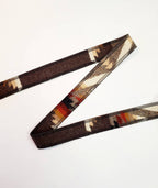Pacific Crest wool hat band folded on a white background to show its brown geometric pattern and finished edges.