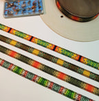 Four trout-patterned hat bands laid side by side beside a hat and fishing fly box.