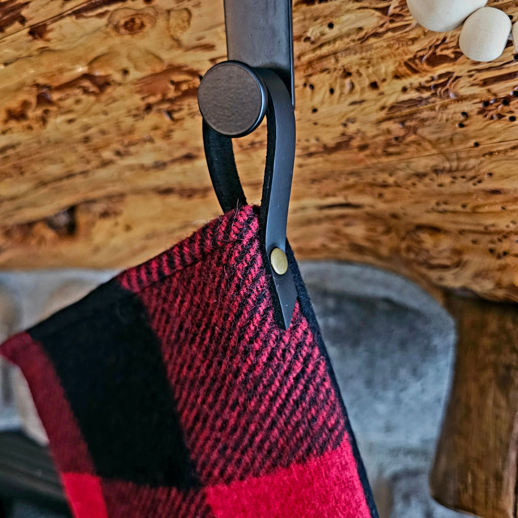Close-up of the hanging loop and red and black buffalo check fabric on a Christmas stocking.