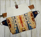 Shonto Wheatlands sling shown flat with its patterned fabric panels and brown strap detached.
