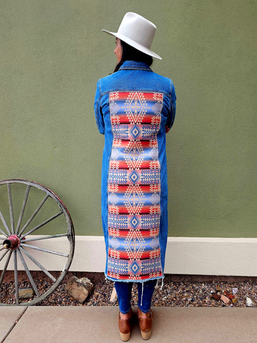 Back view of the Canyonlands denim duster with a long red, blue and cream geometric wool panel.