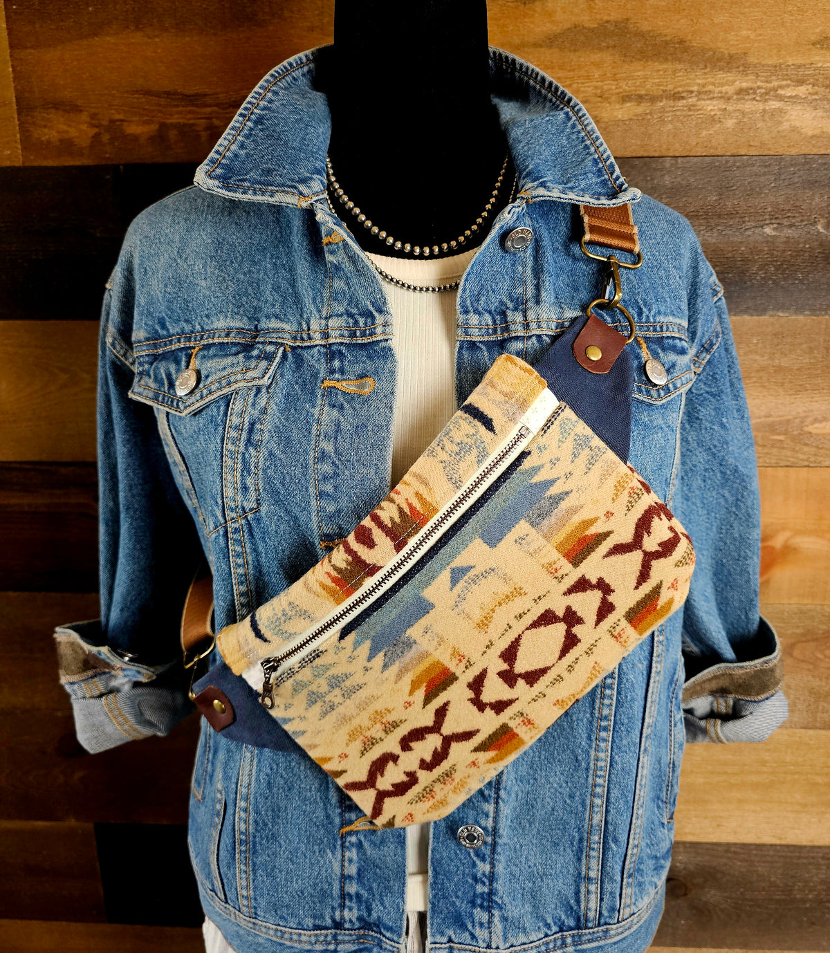 Shonto Wheatlands western sling styled diagonally across a denim jacket on a mannequin.