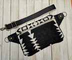 Back view of the Condensed White sling laid flat, with black and cream fabric and black strap.
