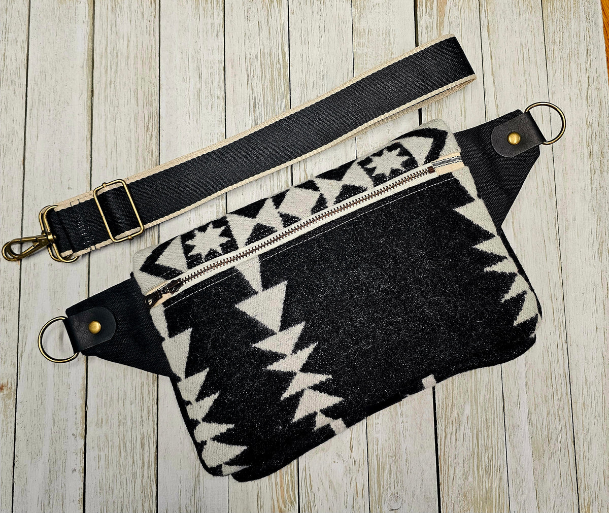 Back view of the Condensed White sling laid flat, with black and cream fabric and black strap.