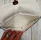 Open Canyonlands sling showing its light-colored lining and interior compartment.